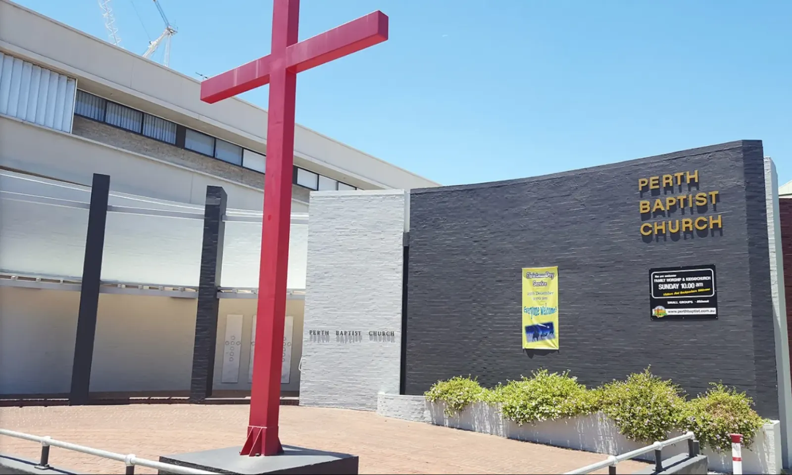 Perth Baptist Church building with its red cross on the corner of James and Stirling Streets