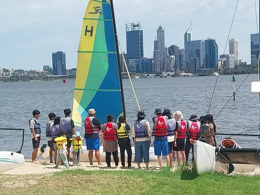 Group by the Swan River with the Perth skyline